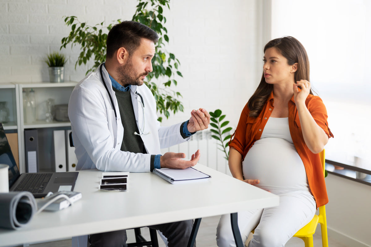 Pregnant woman having a friendly consultation with her doctor