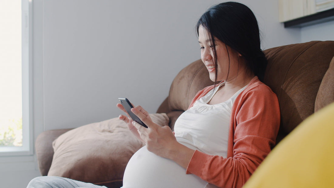 Pregnant woman searching for pregnancy information on her phone